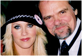 Playboy queen Jenny McCarthy joins Larry at an industry event.